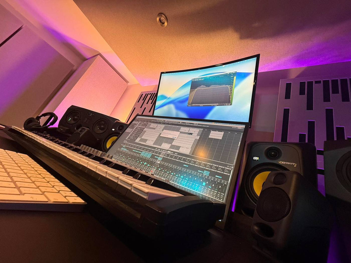 Klubfiller Studios production workspace with keyboards, studio monitors and music production screens